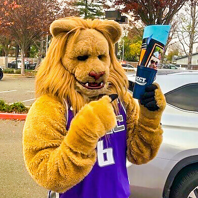 Sacramento Kings Mascot Slamson holds a Family Meal Kit in his paws.